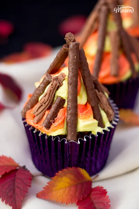 A bonfire cupcake in a dark purple cupcake case.