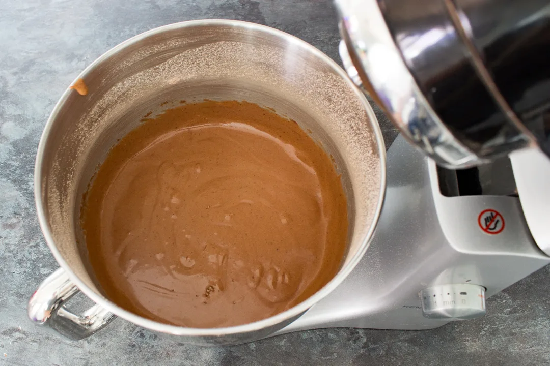 Chocolate cupcake batter in the bowl of an electric stand mixer.