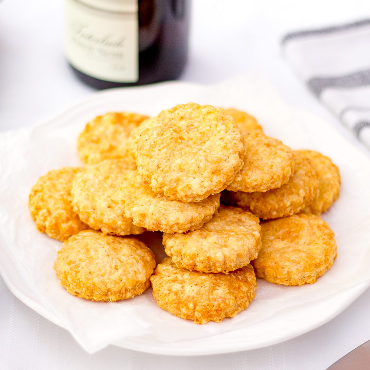 Cheese biscuits stacked on a plate.