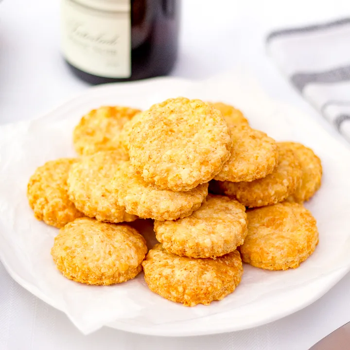 Cheese biscuits stacked on a plate.