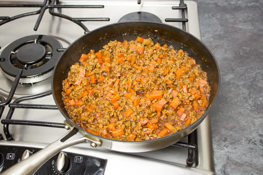 Fully cooked mince and vegetable Shepherd's pie filling in a saucepan, ready to be used.