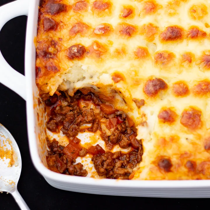 Shepherd's pie in a dish with a spoon at the side