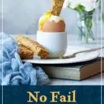 A toast soldier being dunked into a runny boiled egg. A text overlay says "No fail air fryer boiled eggs recipe".