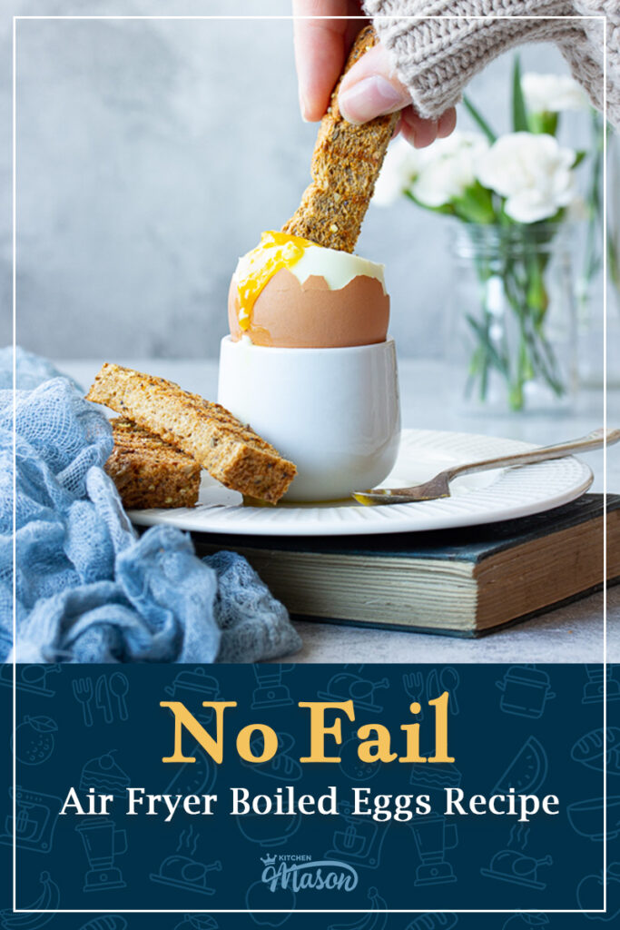A toast soldier being dunked into a runny boiled egg. A text overlay says "No fail air fryer boiled eggs recipe".