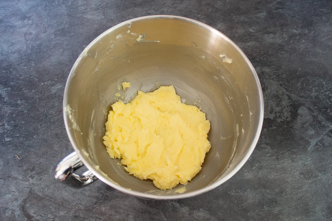 Butter and icing sugar creamed together in an electric stand mixer bowl.