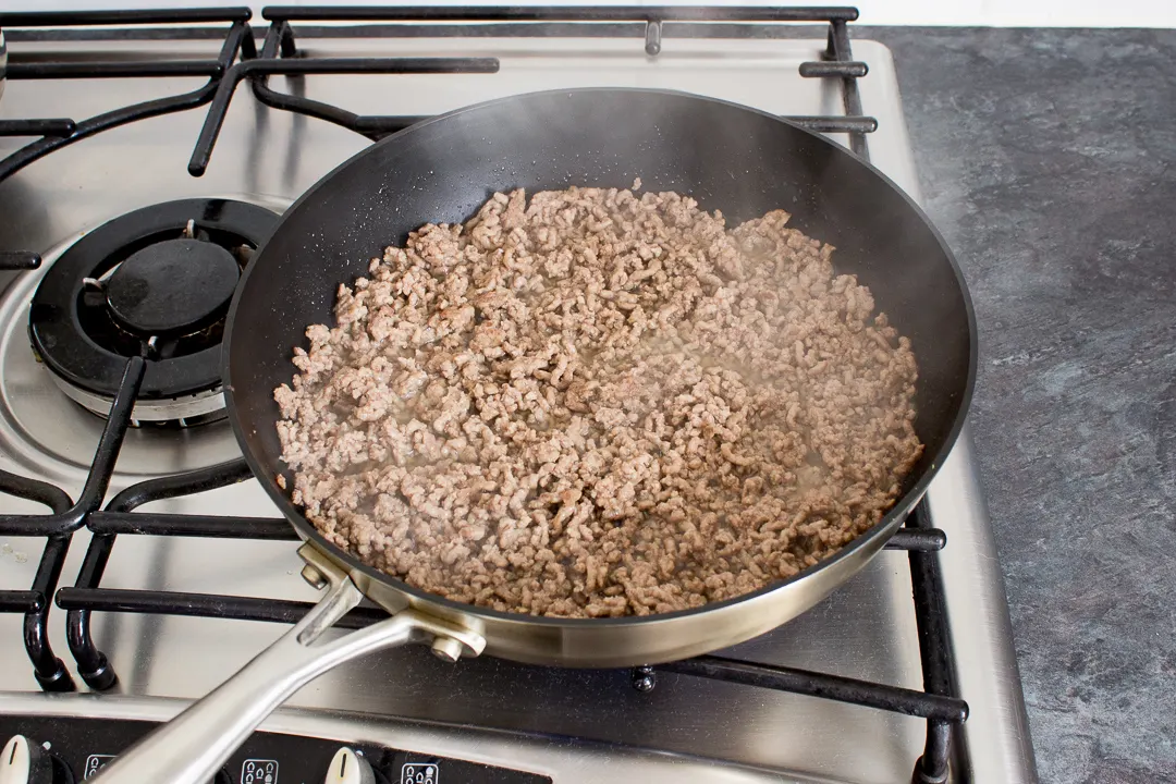 Beef mince frying in a large saucepan.