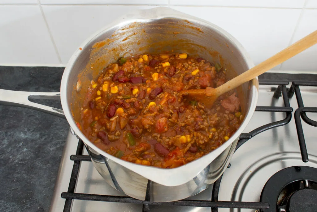 Chilli con carne simmering in a large saucepan.