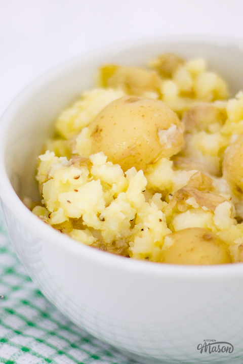A bowl of crushed baby potatoes on a tea towel.