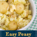A bowl of crushed new potatoes topped with a knob of melting butter. A text overlay says "Easy peasy crushed new potatoes".