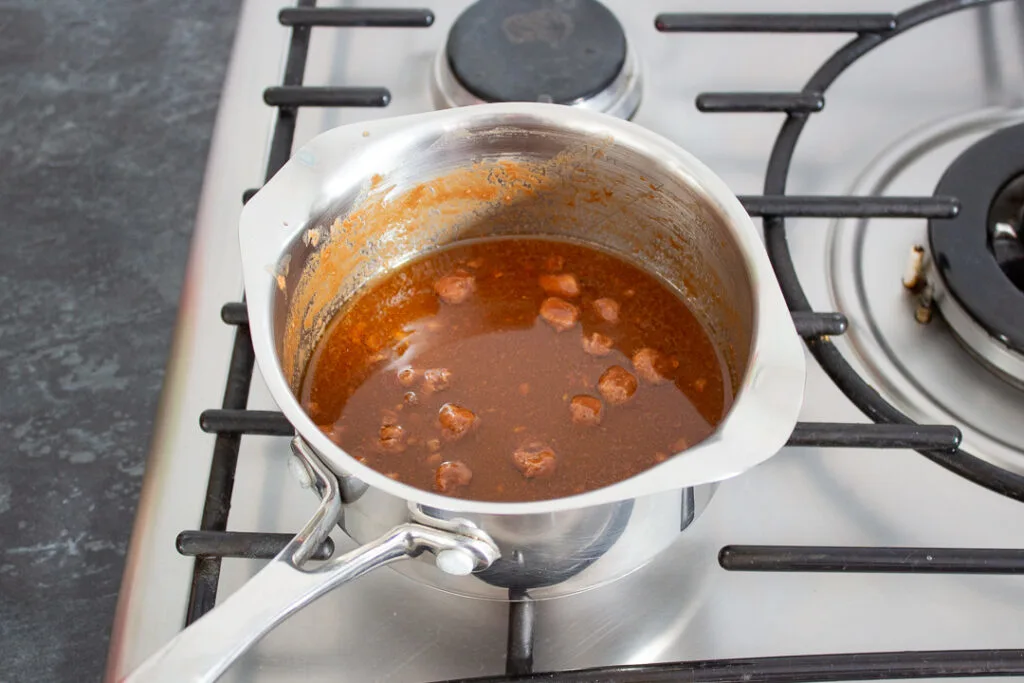 Mars Bars, butter and golden syrup melting in a saucepan.