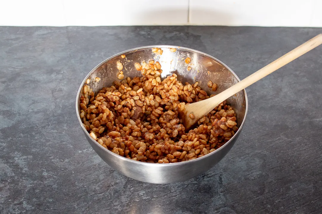 Rice Krispies cereal mixed with melted mars bars in a large mixing bowl.
