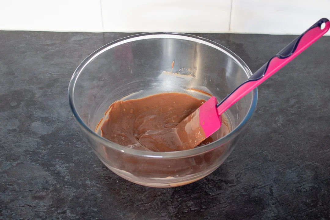 Melted chocolate in a glass bowl.