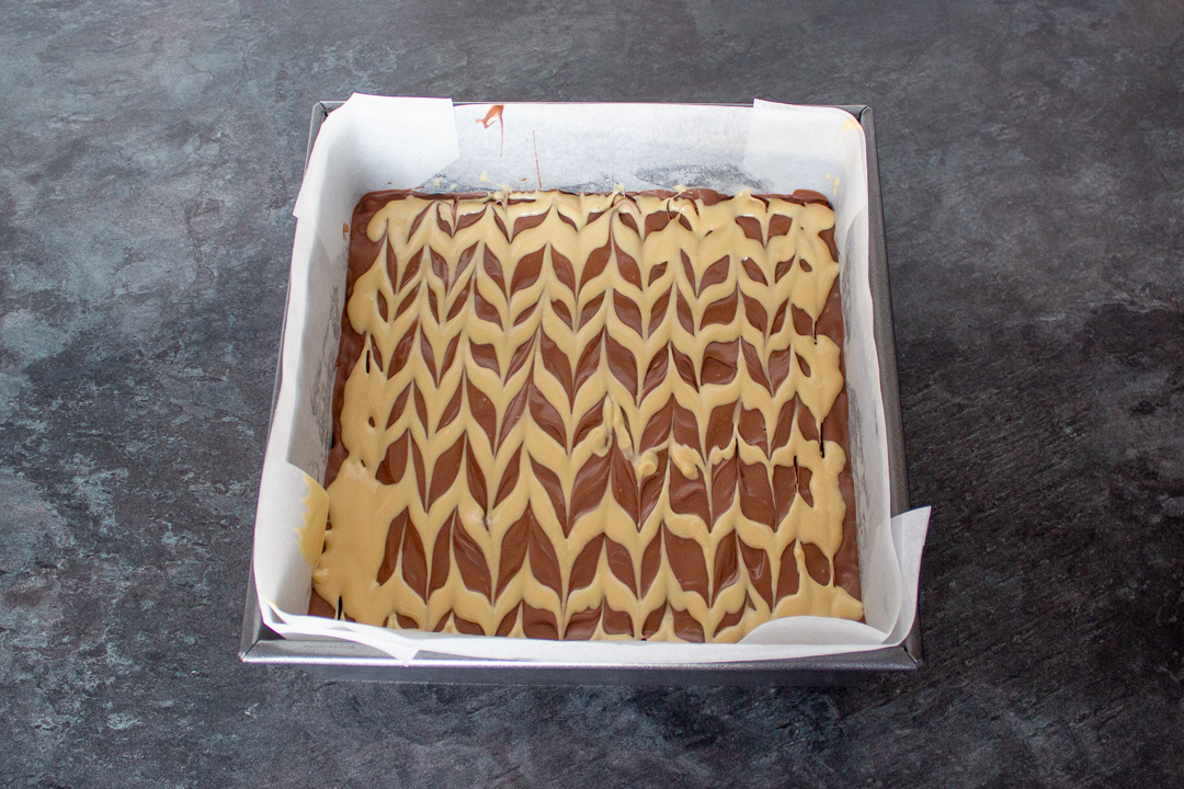Melted Milk chocolate topping with blonde chocolate feathering on top.