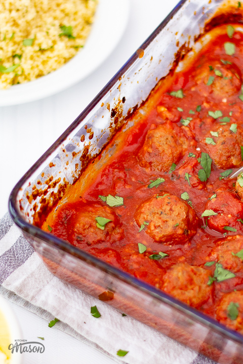 A glass dish filled with turkey meatballs in a tomato sauce.