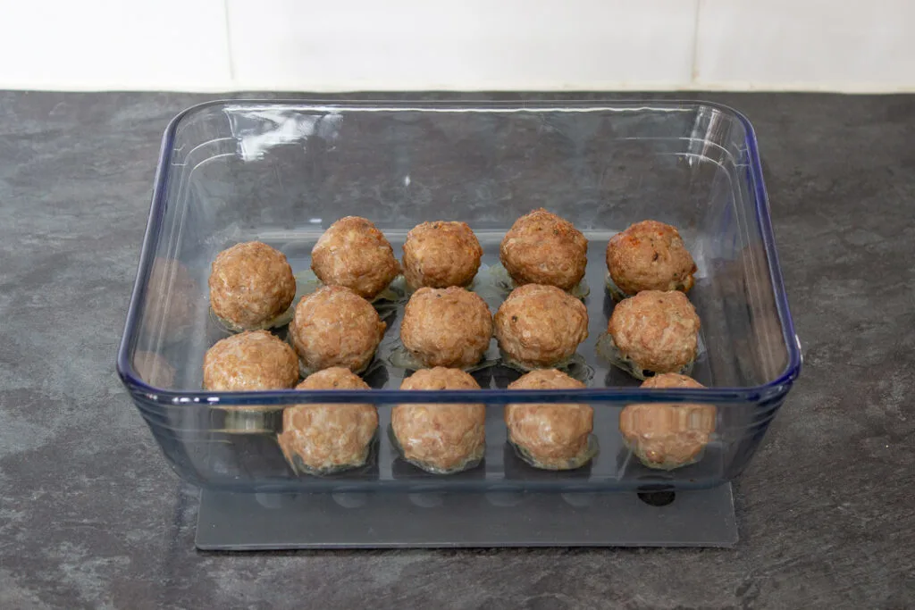Oven baked turkey meatballs in a glass dish.