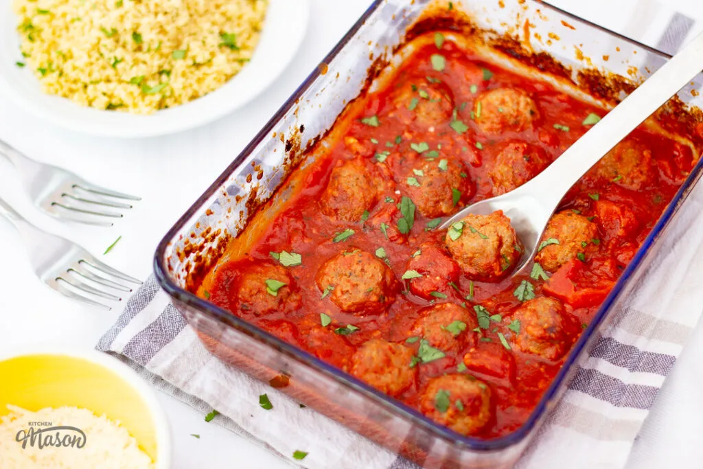 Turkey meatballs and tomato sauce in a glass serving dish.