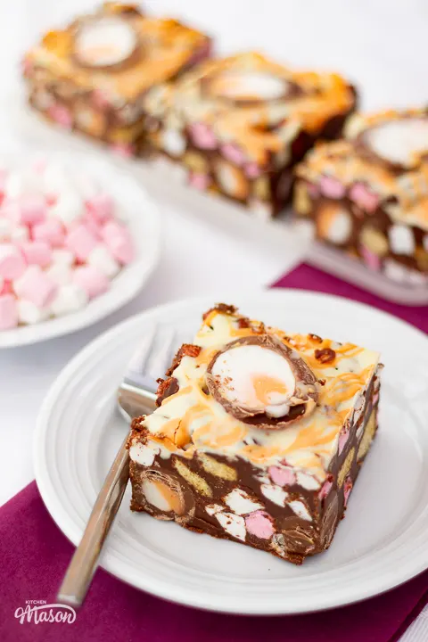 Lots of Creme Egg rocky road bars on servings plates.