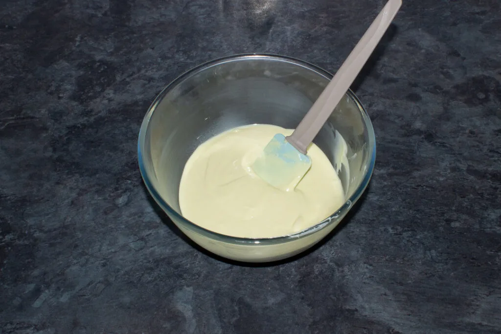 Melted white chocolate in a bowl.