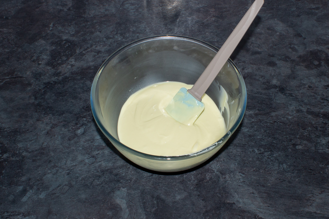 Melted white chocolate in a bowl.