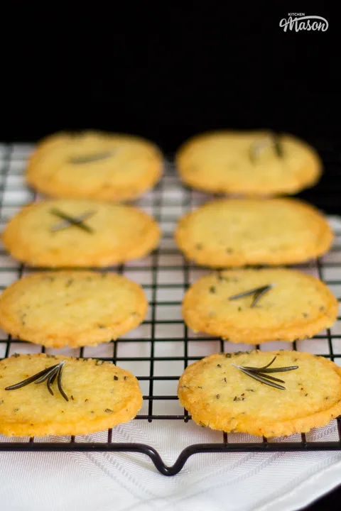 Lots of spicy rosemary crackers cooling on a rack.