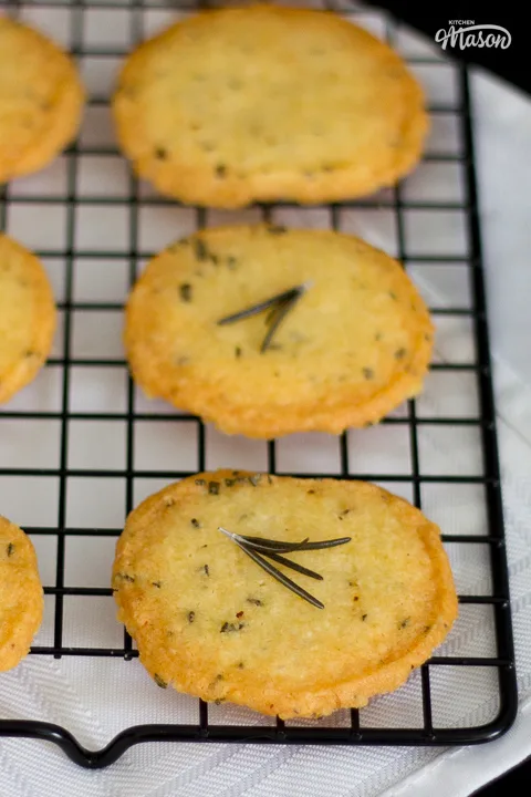 Close up of a freshly baked spicy rosemary flavoured cracker on a wire cooling rack.