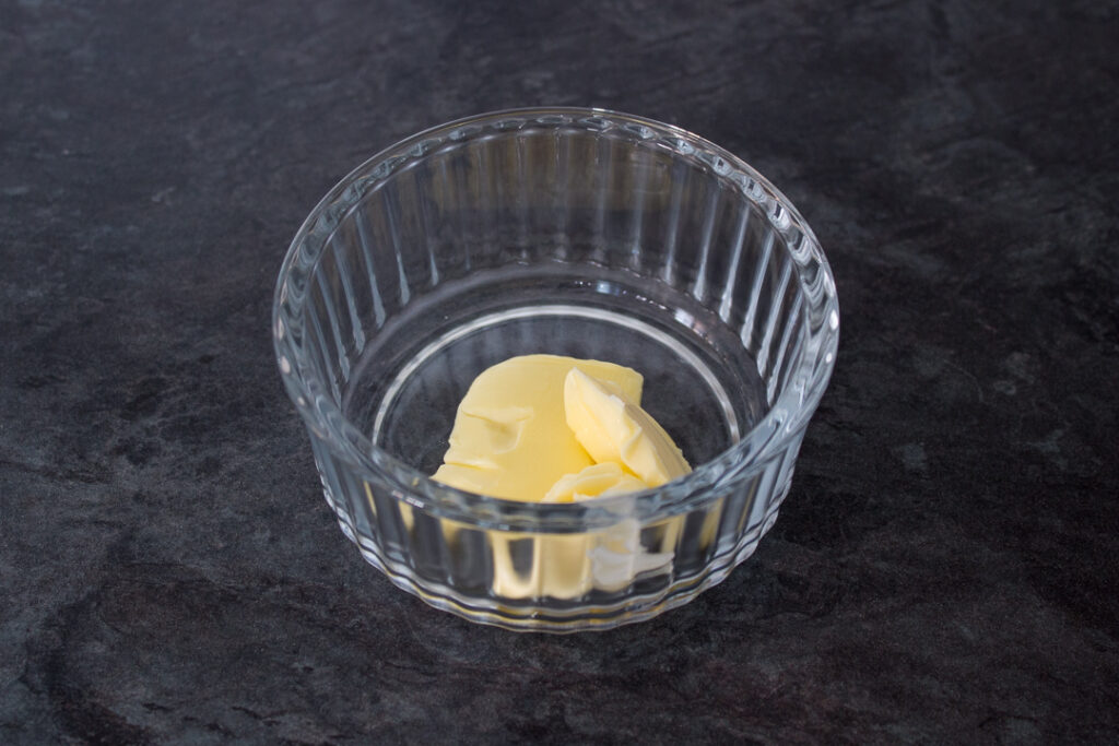 Butter in a glass ramekin.