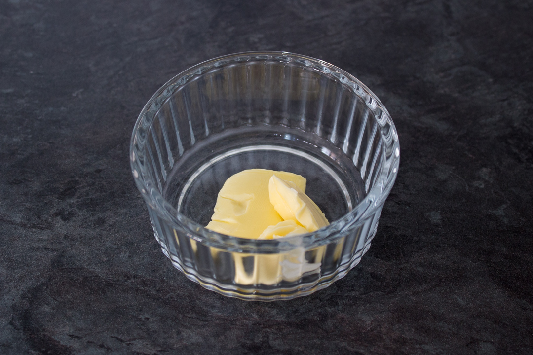 Butter in a glass ramekin.