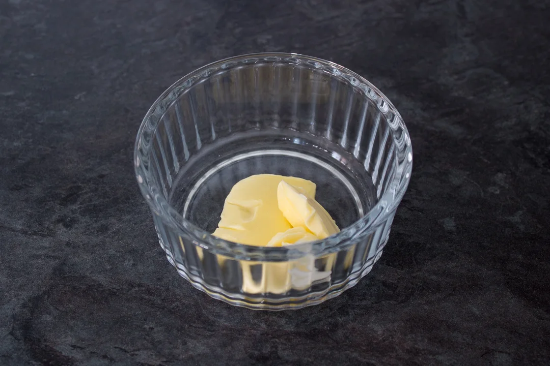 Butter in a glass ramekin.