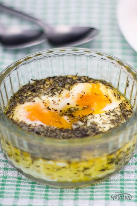 Thyme baked eggs in a glass ramekin.
