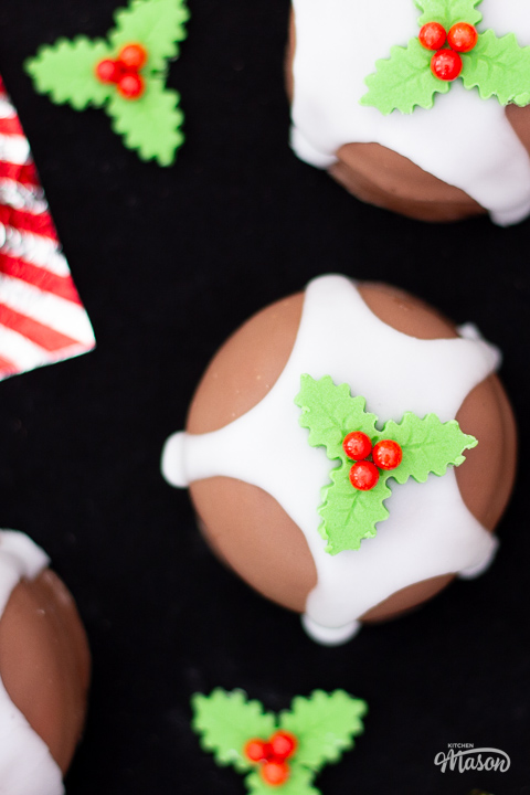 A Christmas pudding teacake on a black surface.