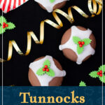 Tunnocks Christmas pudding teacakes on a black surface with gold curling ribbon and homemade holly and ivy sugar decorations at the side. A text overlay says "Tunnocks Christmas pudding teacakes".