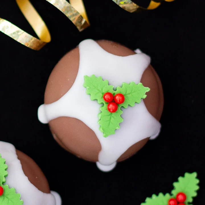 A Tunnocks teacake turned into a Christmas pudding with icing and a holly and ivy sugar decoration.