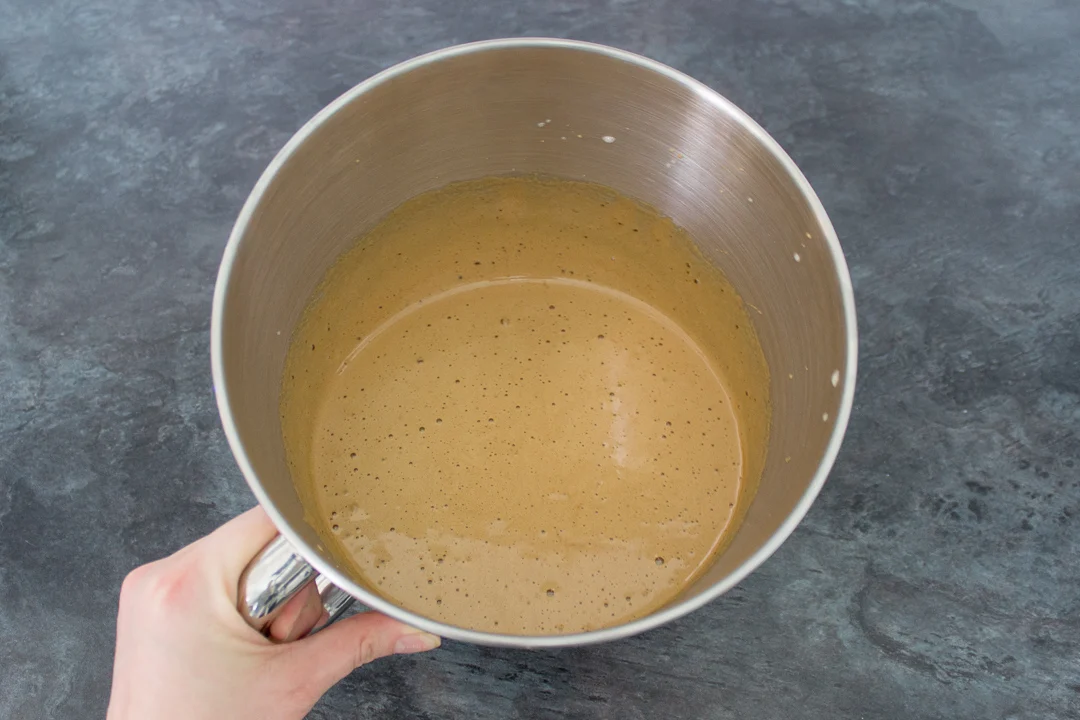 Whisked eggs and dark muscovado sugar in a mixing bowl.