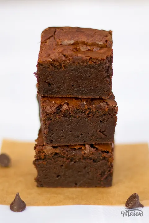 A stack of 3 fudgy chocolate brownies.