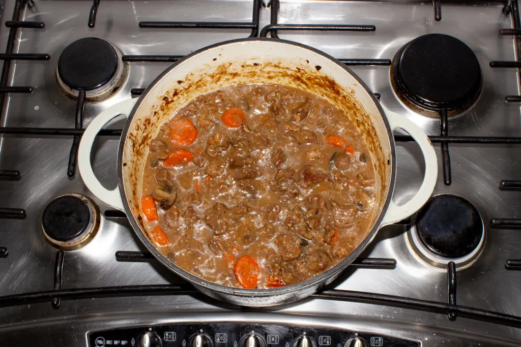 Oven cooked beef casserole in a large pot.