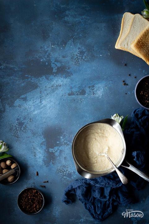 A saucepan filled with bread sauce, and lots of little bowls filled with spices.
