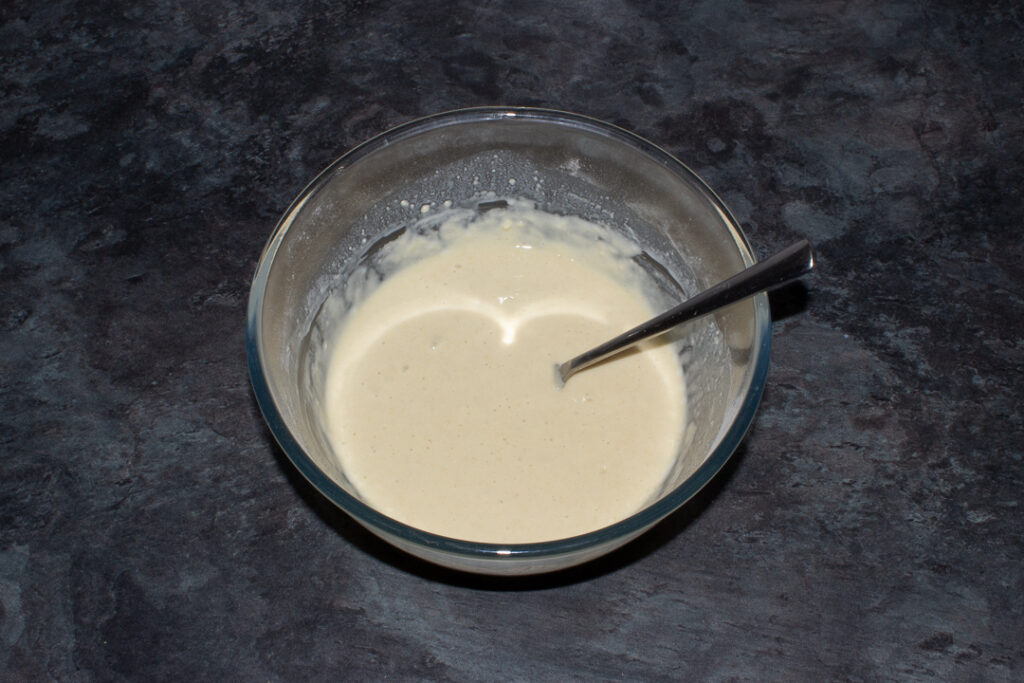 Scotch pancake batter in a glass mixing bowl.
