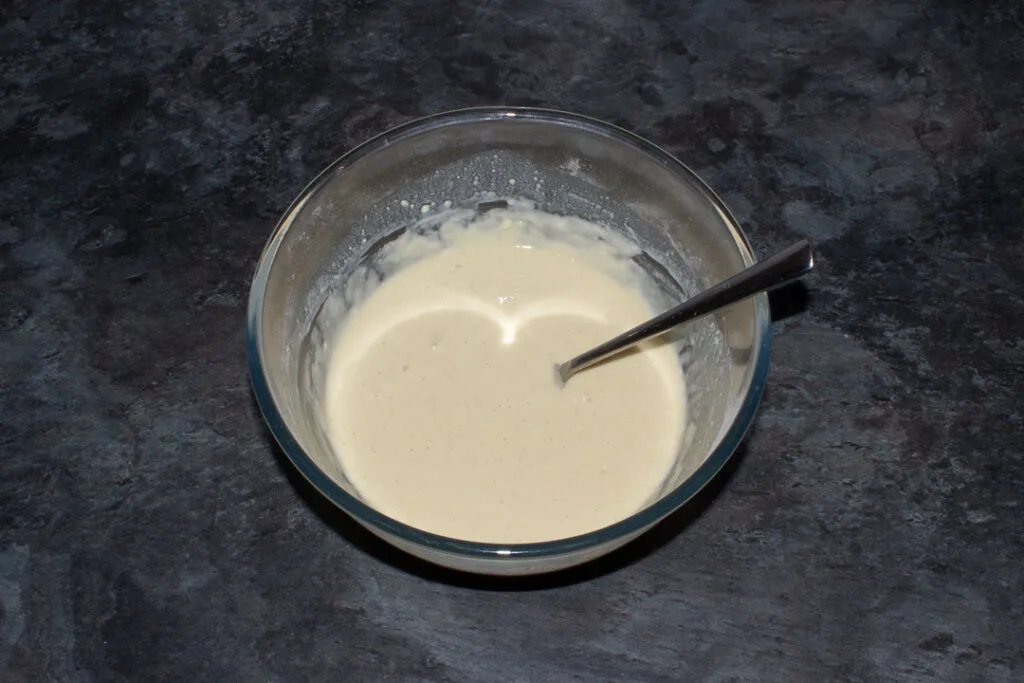 Scotch pancake batter in a glass mixing bowl.