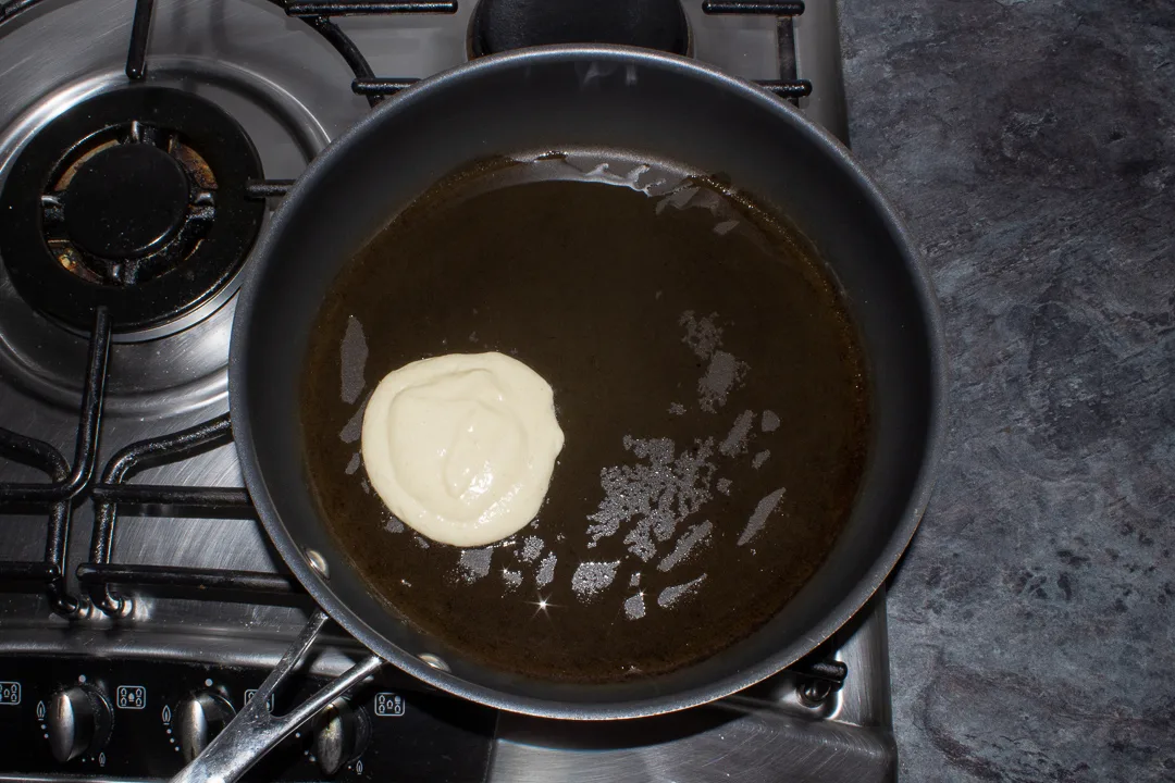 Drop scone batter in a frying pan on the stove.