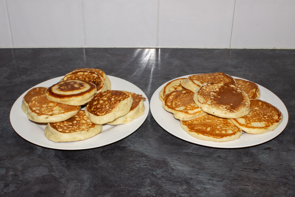 Two plates of drop scones, one set is thicker and fluffier than the other.