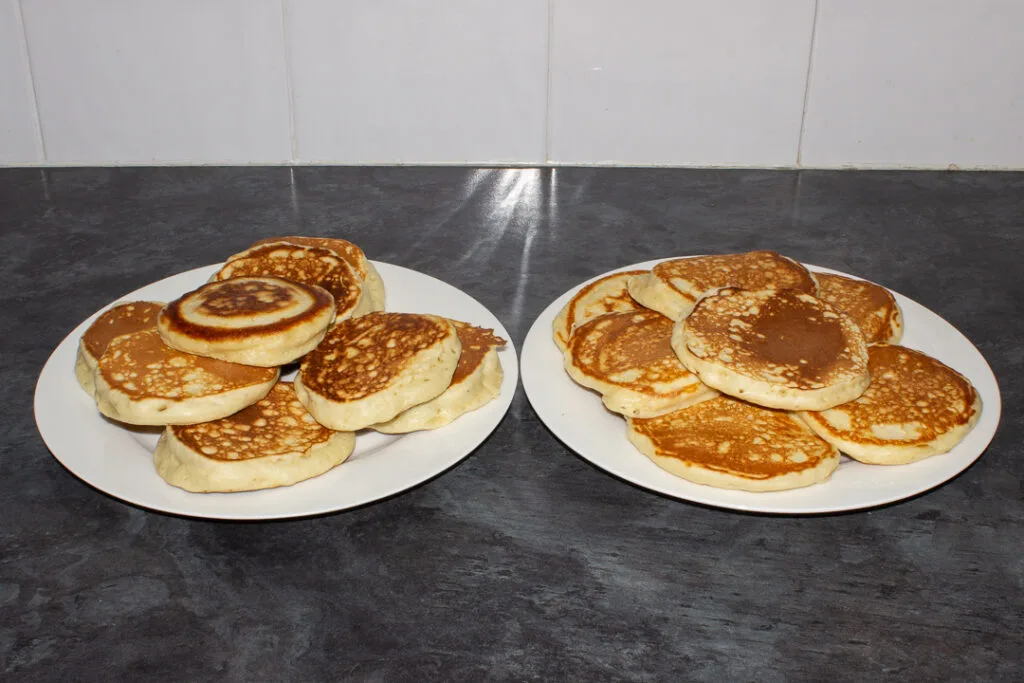 Two plates of drop scones, one set is thicker and fluffier than the other.