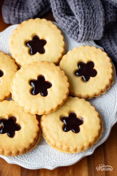 A plate of homemade jammy dodgers on a worktop.