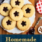 A white decorative plate of 6 homemade jammy dodgers with a spoon filled with jam to the side. A text overlay says "Homemade black cherry jammy dodgers".