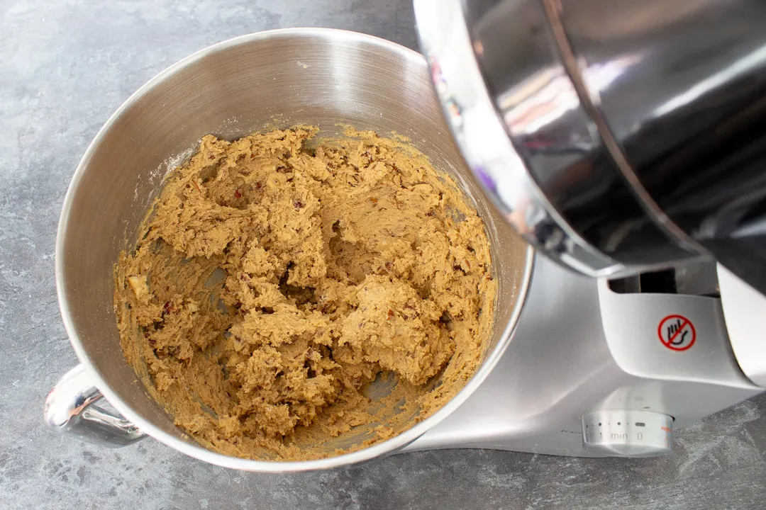 Nut biscuit dough in the bowl of an electric stand mixer.