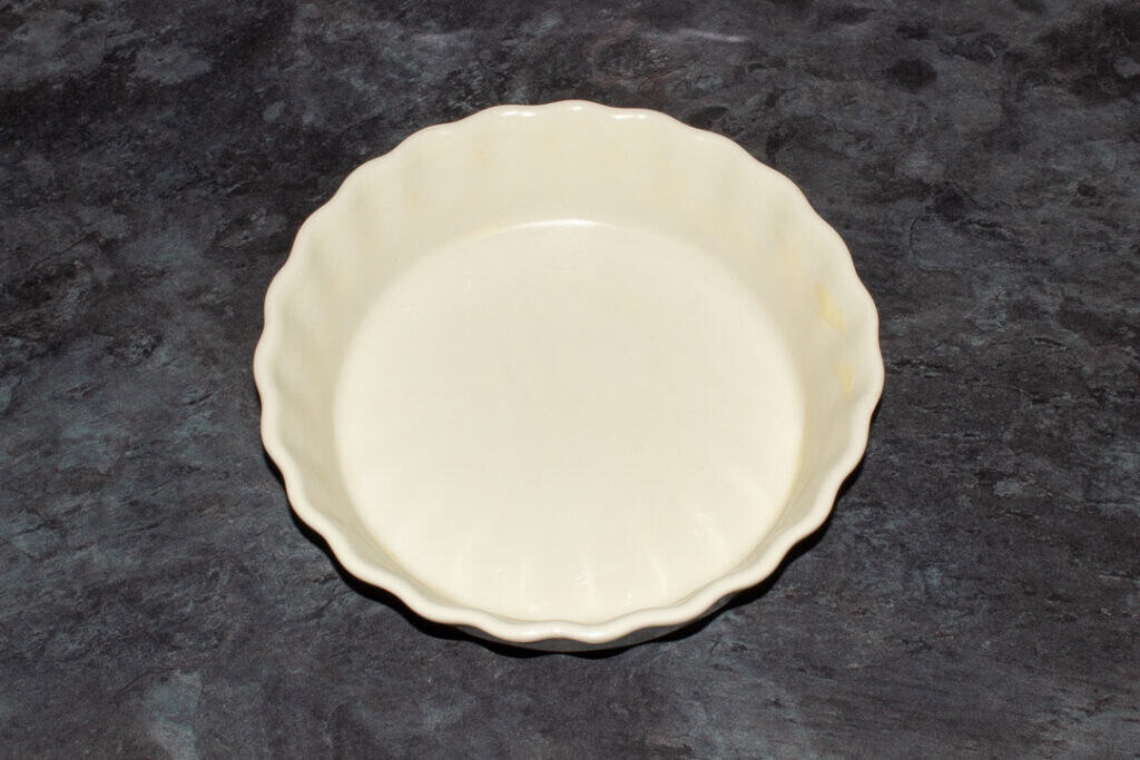 A greased baking dish on a kitchen worktop.