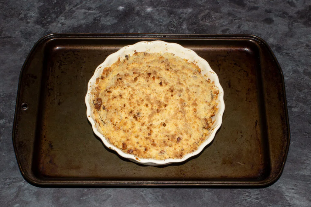 A baked pear crumble, with a crispy golden brown topping.