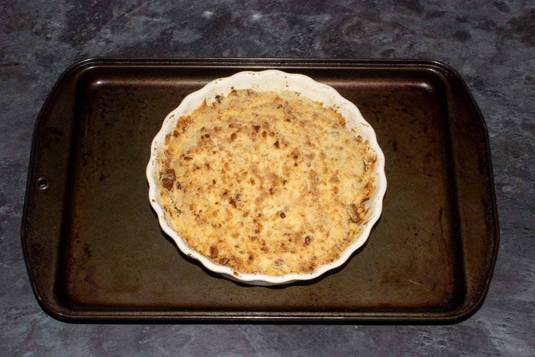 A baked pear crumble, with a crispy golden brown topping.