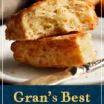 A cheese scone split in half on a plate with a knife. It looks golden, light, and flaky. A text overlay says "Gran's Best easy cheese scones".
