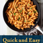 A large frying pan filled with creamy bacon pasta over a wooden board. A text overly says "Quick and easy creamy bacon pasta recipe".