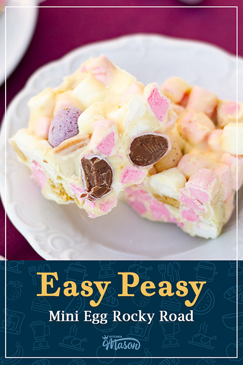 Two white chocolate Mini Egg rocky road bars on a decorative plate over a purple napkin. A text overlay says "Easy peasy Mini Egg Rocky Road".